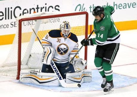 Stars forward Jamie Benn tried to get the puck past Sabres goalie Chad Johnson during the third period