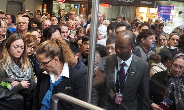 Travelers wait in line at Charles De Gaulle airport in Paris France on November 14th