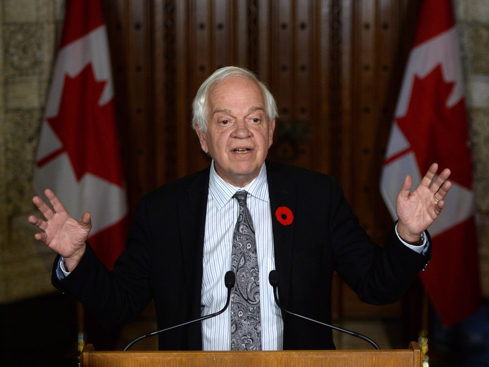 John McCallum minister of Immigration Refugees and Citizenship speaks to reporters in the foyer of the House of Commons on Parliament Hill in Ottawa on Monday Nov. 9 2015