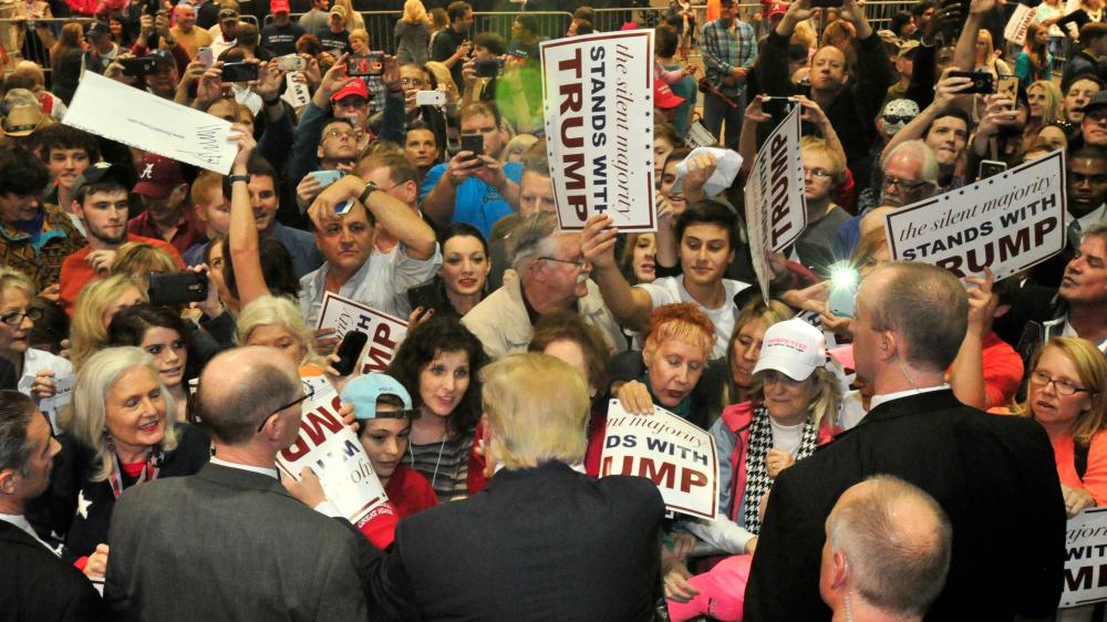 Trump supporters hit, kick black protester at Alabama rally