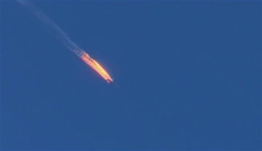 This frame grab from video by Haberturk TV shows a Russian warplane on fire before crashing on a hill as seen from Hatay province Turkey Tuesday Nov. 24 2015. Turkey shot down the Russian warplane Tuesday claiming it had violated Turkish airspace