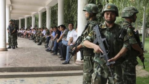 Paramilitary police seen during a ceremony to award those authorities say participated in'the crackdown of violence and terrorists activities in Hotan Xinjiang in 2014