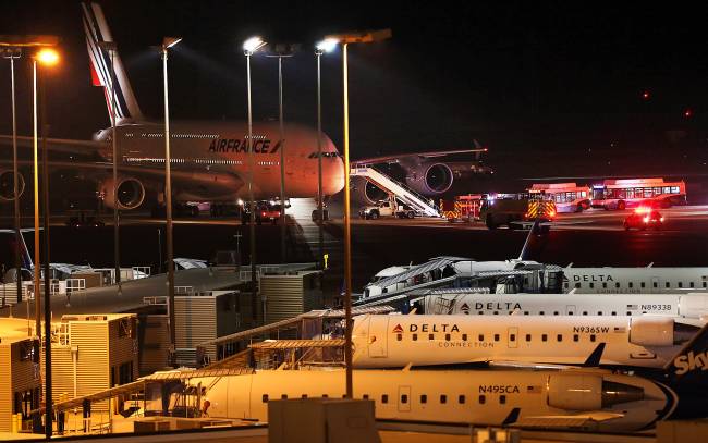 Emergency vehicles are parked near an Air France plane that was diverted to Salt Lake City International Airport Tuesday Nov. 17 2015 in Salt Lake City. Officials said two Air France flights bound for Paris from the U.S. had to be diverted because