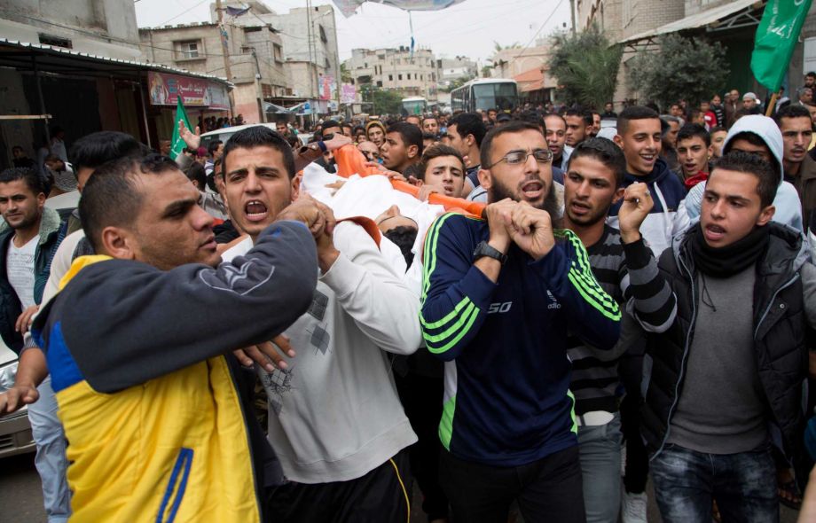 Palestinian mourners chant Islamic slogans while carrying the body of fisherman Faris Meqdad 18 during his funeral in Rafah Gaza Strip Friday Nov. 6 2015. Palestinian Health Ministry spokesman Ashraf al Kidra says the 18-year-old fisherman was shot