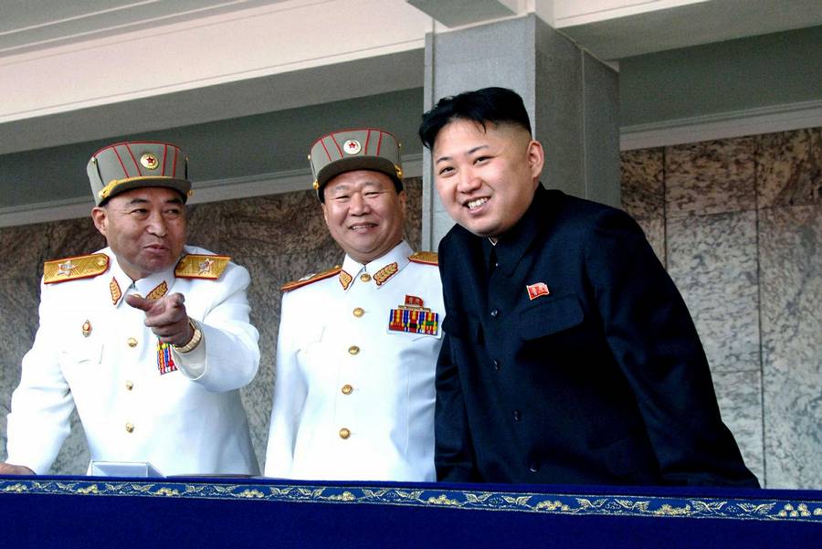 North Korean leader Kim Jong-un right smiles with the Korean People's Army senior officers Vice Marshal and Vic