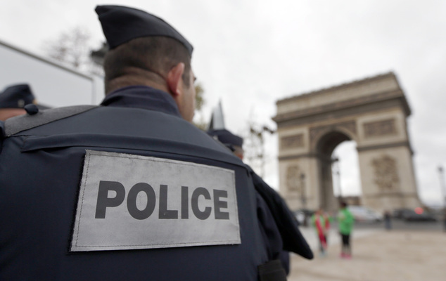 Police forces patrol near the landmark the Arc de Triomphe in Paris Tuesday Nov. 17 2015. France's Interior Minister Bernard Cazeneuve has said that aut