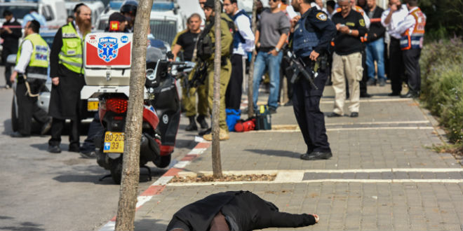 Israeli security and rescue forces near the body of a Palestinian woman who stabbed a security guard at the scene of a stabbing attack in the entrance to Beitar Illit in the West Bank