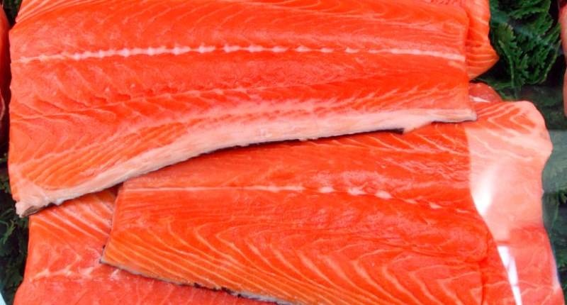 Slabs of salmon are displayed at a market