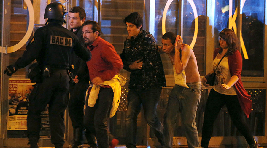 French special forces evacuate people including an injured man holding his head as people gather near the Bataclan concert hall following fatal shootings in Paris France