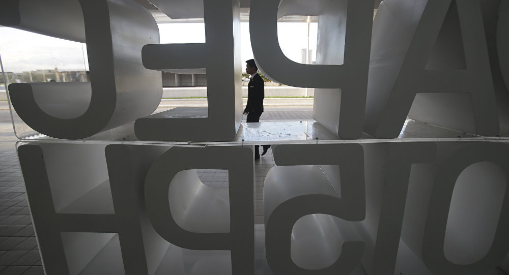 A man walks in front of the APEC 2015 logo in Manila Philippines on Sunday Nov. 15 2015