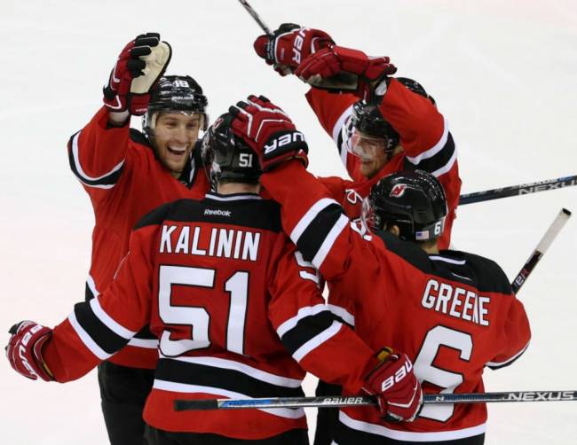 Devils center Travis Zajac, center Adam Larsson and defenseman Andy Greene celebrate a goal by center Sergey Kalinin during the second period against Vancouver Canucks Sunday Nov. 8 2015 Newark