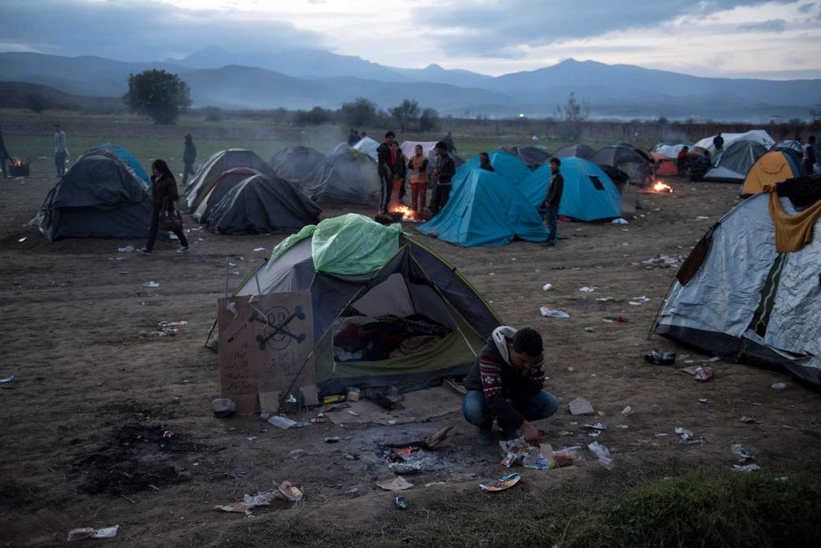 Migrants try to warm up around a bonfire near the village of Idomeni at the Greek Macedonian border on Monday Nov. 23 2015. Several European countries including EU members Slovenia and Croatia and non-members Serbia and Macedonia have declared they