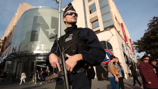 A French policeman stands guard outside a commercial centre in Nice France the day after a series of deadly attacks in Paris. France and other countries have beefed-up security after Friday night's shootings and bombings