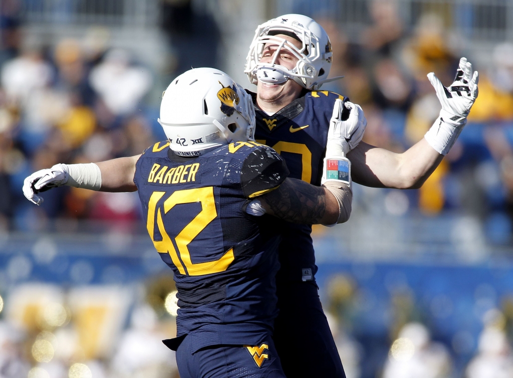 497160474 Mountaineers&#39 Justin Arndt right celebrates after recovering a fumble on a kick return in the second half against the Texas Longhorns Saturday at Mountaineer Field in Morgantown WW