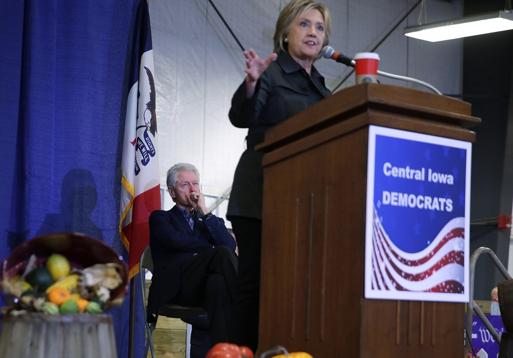 AMES IA- NOVEMBER 15 Democratic presidential candidate Hillary Clinton speaks as her husband and former President Bill Clinton looks on during the Central Iowa DemocratsÕ fall barbecue