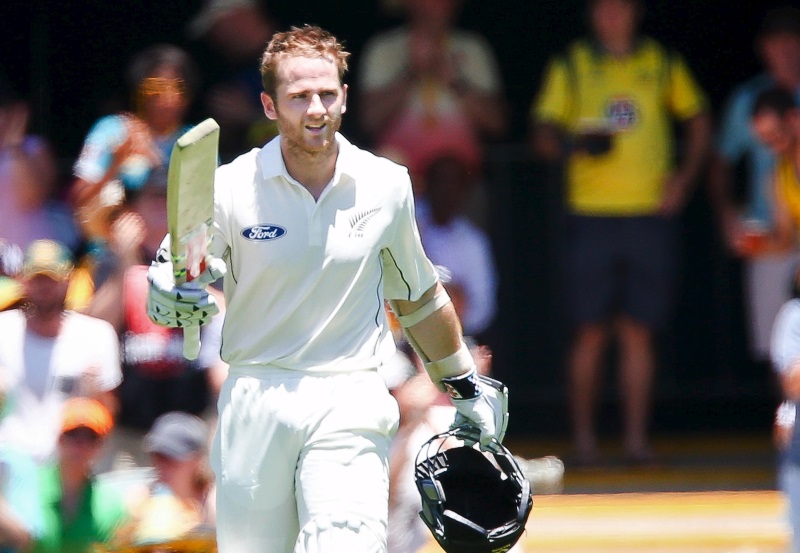 New Zealand batsman Kane Williamson raises his bat after getting his century during the first cricket test match between Australia and New Zealand in Brisbane