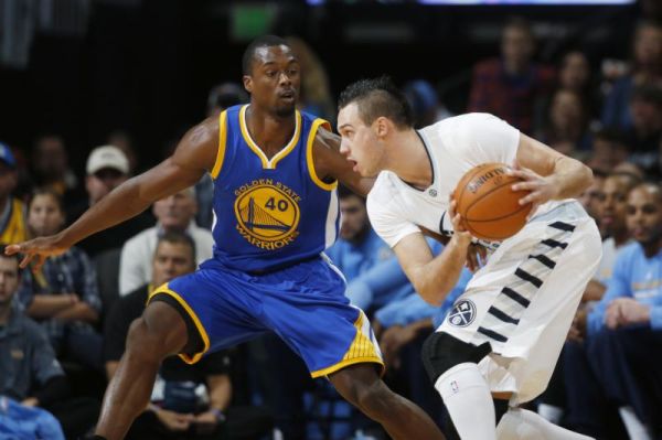 Golden State Warriors forward Harrison Barnes left defends