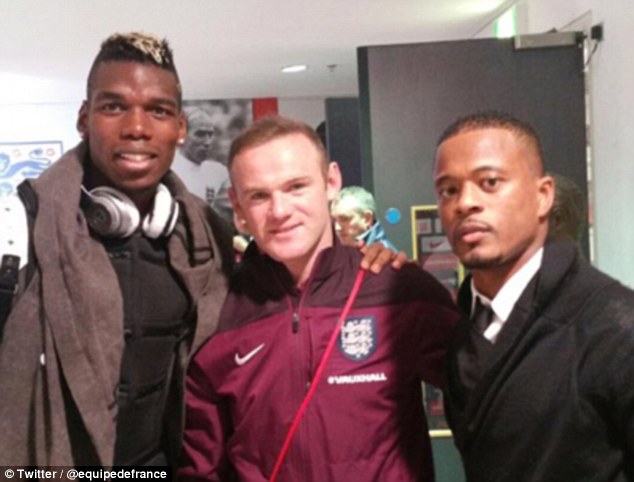 Wayne Rooney poses with France duo Paul Pogba and defender Patrice Evra at Wembley