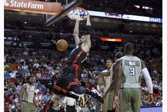 Raptors centre Jonas Valanciunas scored 16 points in the first half Sunday including this dunk in front of Miami's Dwyane Wade. But Valanciunas had just one second-half point