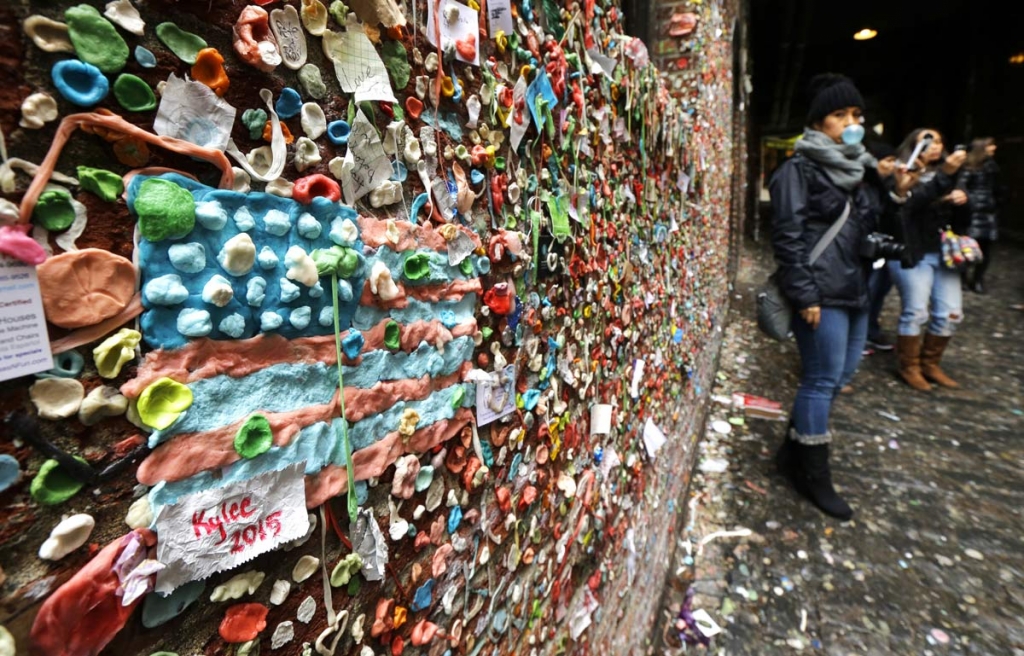 The likeness of an American flag made from pieces of gum sticks to a wall at Seattle's'gum wall at Pike Place Market Monday Nov. 9 2015