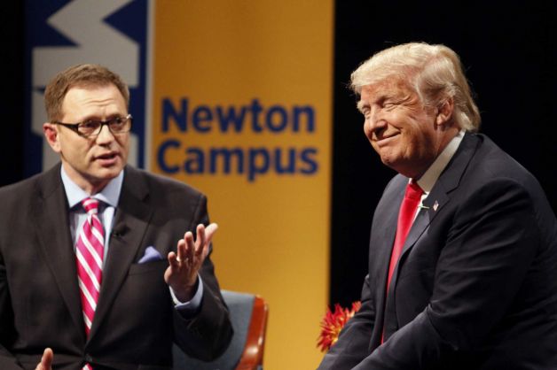 Republican presidential candidate Donald Trump laughs with host Dave Price during the WHO-HD Iowa Forums at the Des Moines Area Community College Newton Campus Thursday Nov. 19 2015 in Newton Iowa