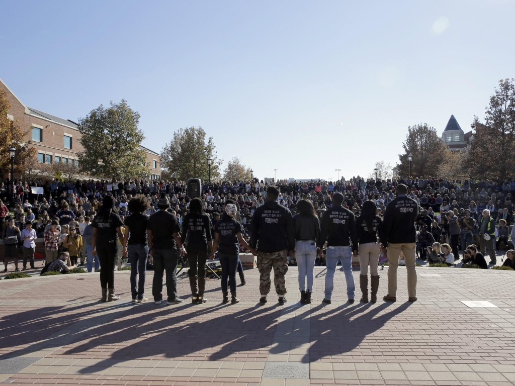 Members of black student protest group Concerned Student 1950 hold hands following the announcement University of Missouri System President Tim Wolfe would resign