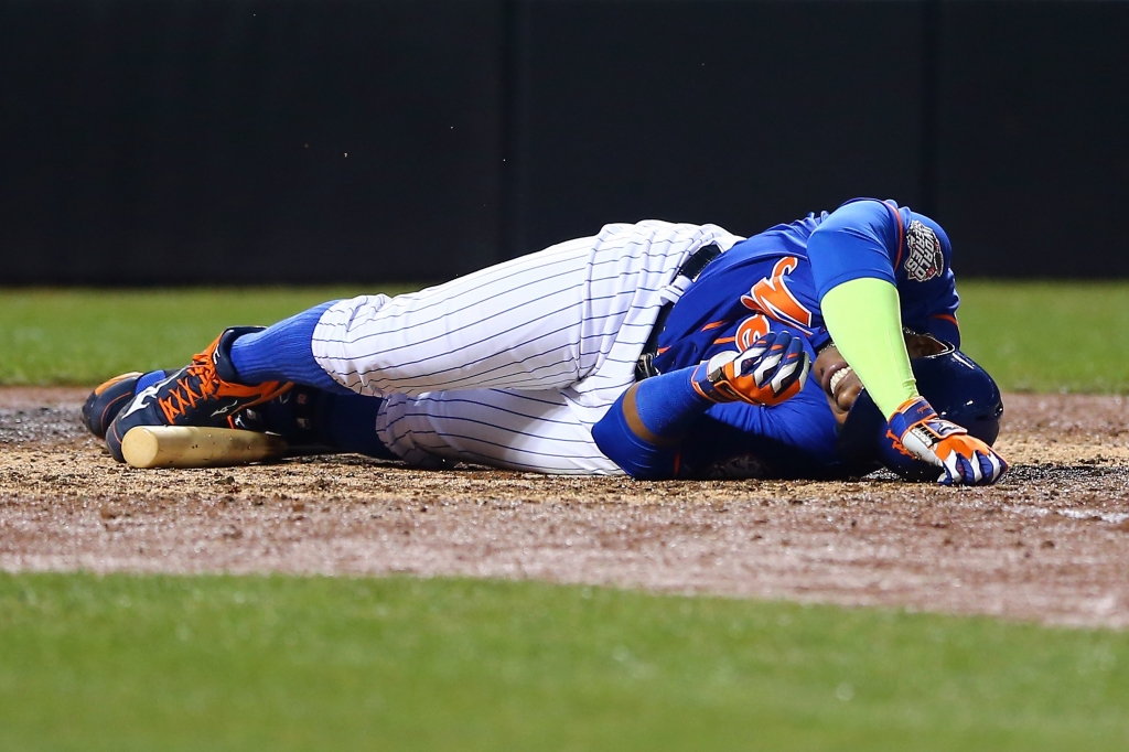 Yoenis Cespedes of the New York Mets lies on the ground after fouling the ball off of his leg in the sixth inning against the Kansas City Royals during Game 5 of the World Series at Citi Field on Nov. 1 2015