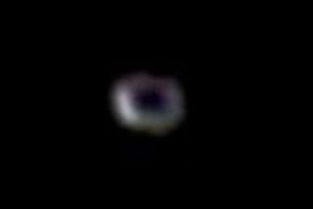 Bizarre donut UFO is caught on camera flying past the International Space Station