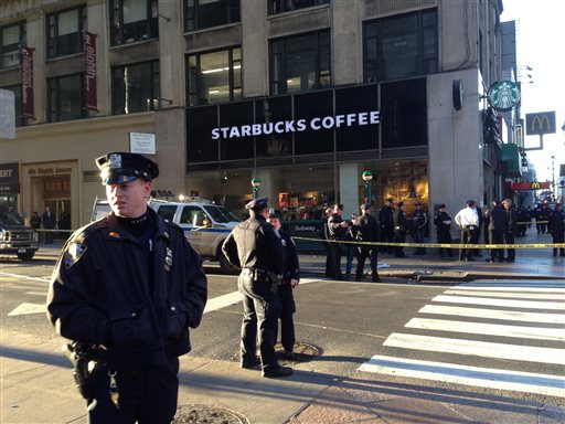 New York Police Department officers investigate a shooting at 35th Street and Eighth Avenue Monday Nov. 9 2015 in New York. Authorities said three people have been shot one fatally. No suspects have been arrested