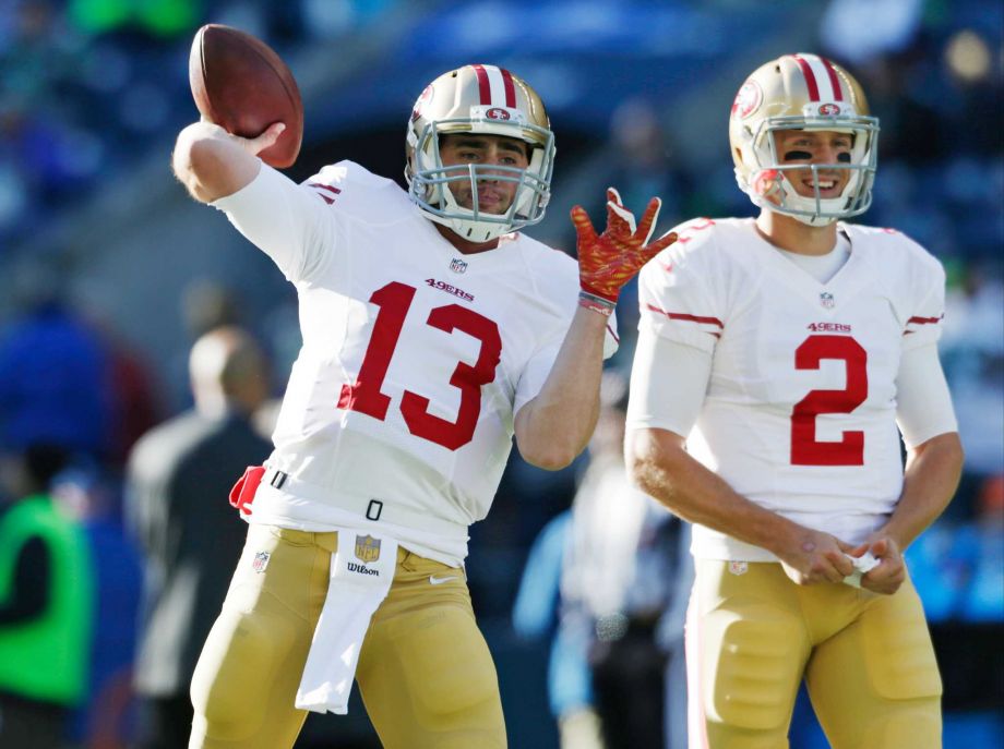 Niners backup quarterback Dylan Thompson warms up Sunday in Seattle as starter Blaine Gabbert watches