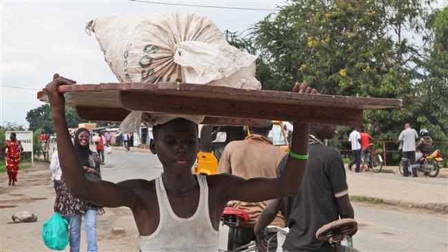 A Burundian man carries his belongings on his head in Bujumbura Burundi