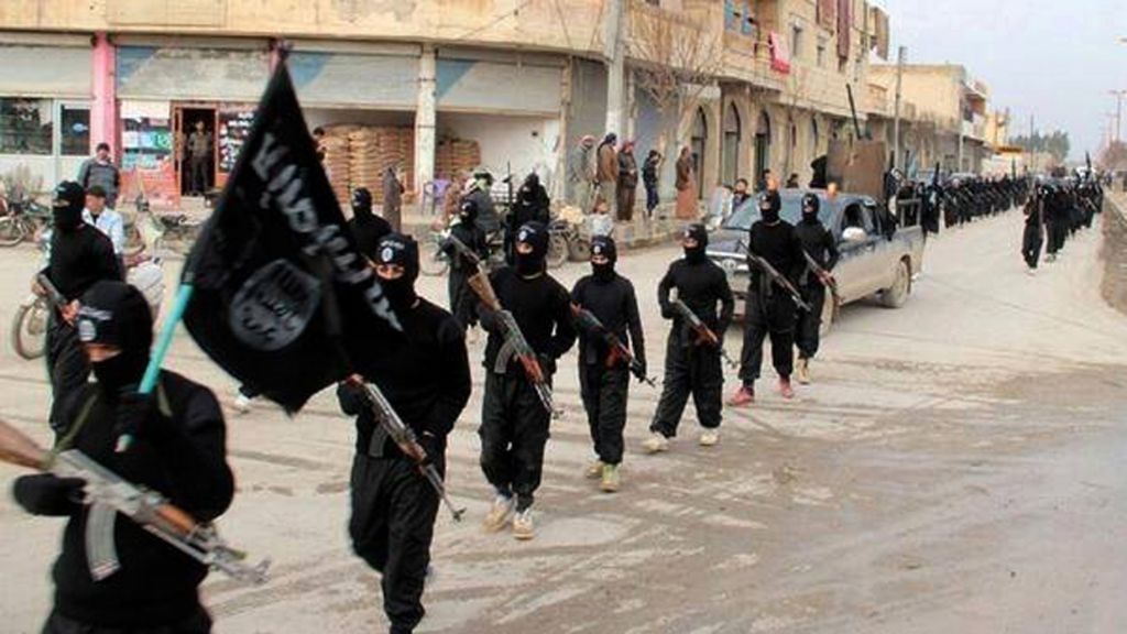 This undated file image posted on a militant website on Jan. 14 2014 shows Islamic State fighters marching in Raqqa Syria