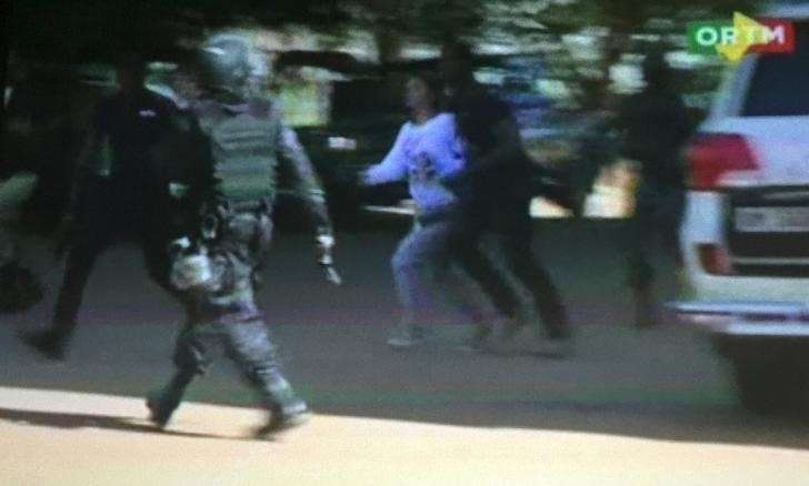 Still image from video show a hostage rushed out from the Radisson hotel in Bamako Mali