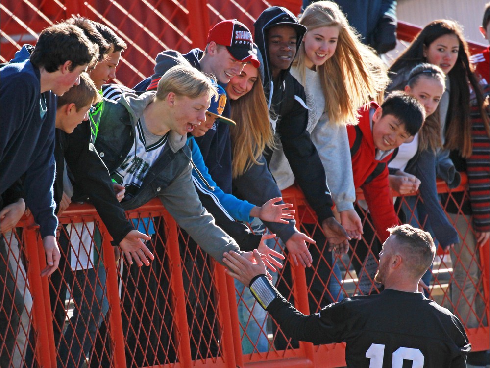 Calgary Stampeders quarterback Bo Levi Mitchell loves meeting with fans such as these students from Madeleine d'Houet school who high-fived him during an October practice. The pivot plans to have fun with fans this week at the Grey Cup