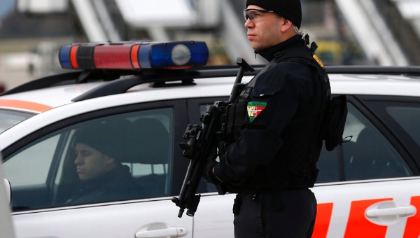 A Geneva police staff holds his position at Geneva International airport in Geneva Dec.10 2015