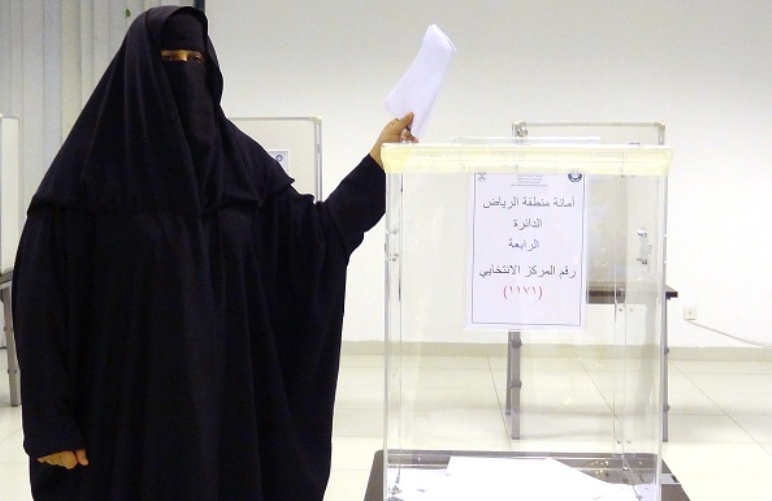 A Saudi woman casts her ballot in a polling station in the coastal city of Jeddah