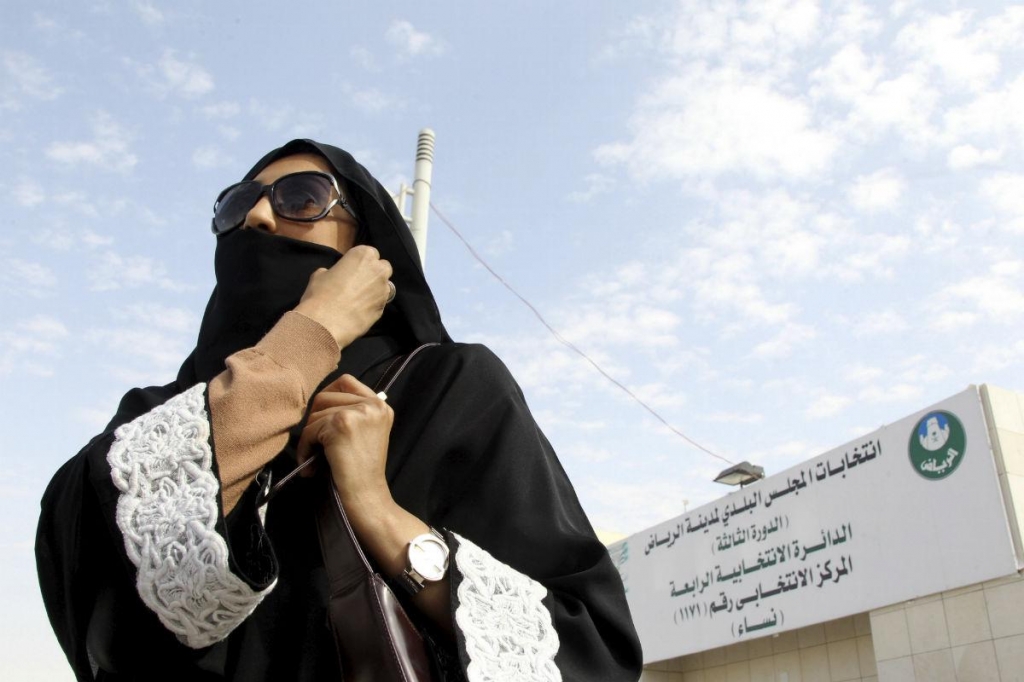 A Saudi woman leaves a polling station after casting her vote during municipal elections