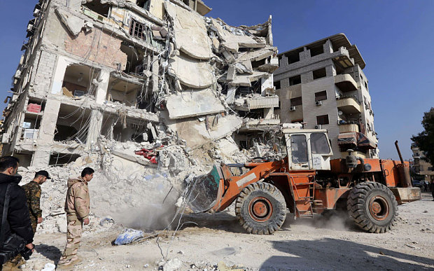 A bulldozer clearing debris from the site