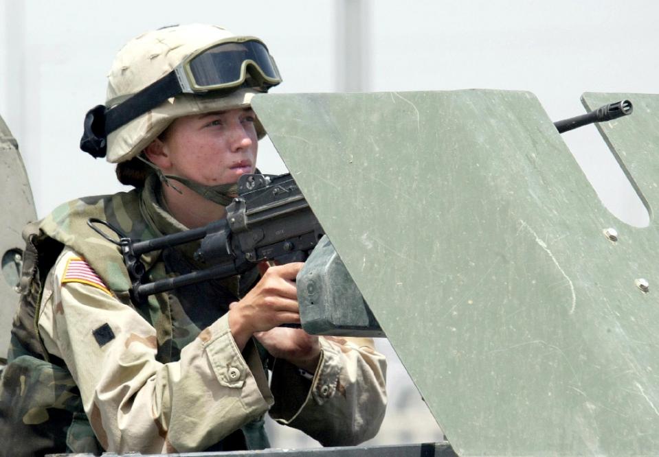 A female US soldier mans a machine gun on a vehicle in the northern Iraqi city of Mosul