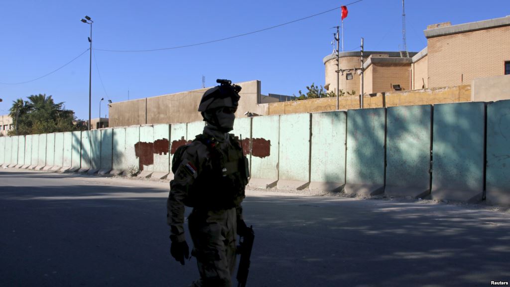 A member from Iraqi security forces walks past the Turkish embassy in Baghdad Dec. 8 2015