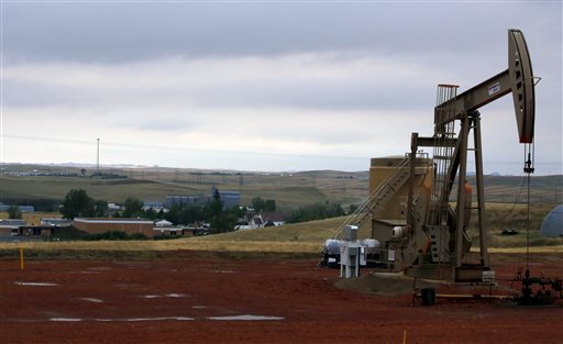 A pump jack pumps oil on a hill above Alexander N.D