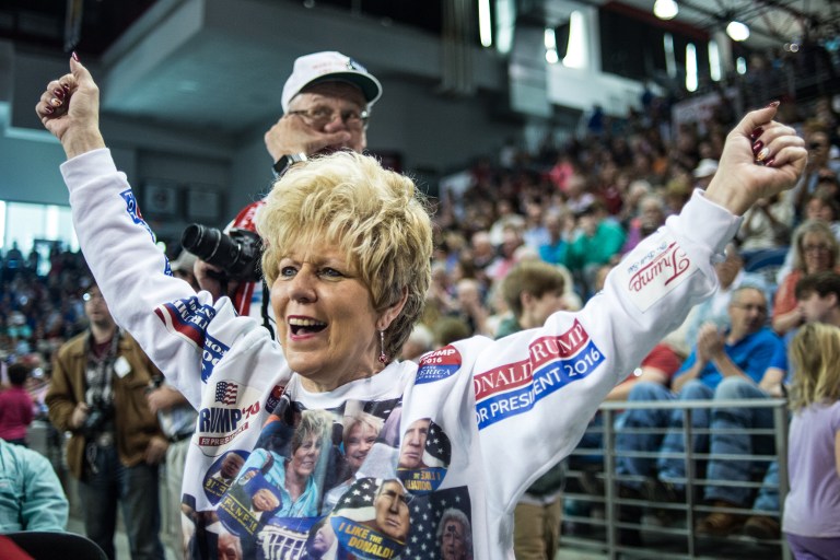 A woman cheers for Donald Trump before a town hall meeting Saturday