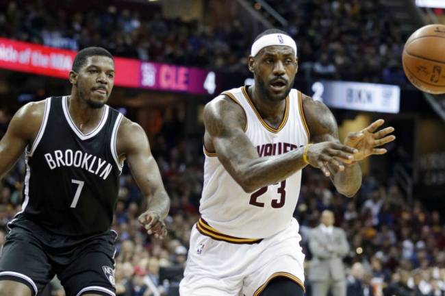 Cavaliers&#39 Le Bron James passes in front of Brooklyn Nets’ Joe Johnson in the first half