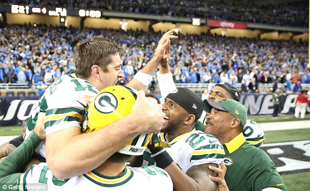 Aaron Rodgers is mobbed by his team-mates after the game-winning pass to make it 27-23 to Green Bay