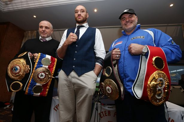 Tyson Fury poses with trainer Peter Fury and father John Fury