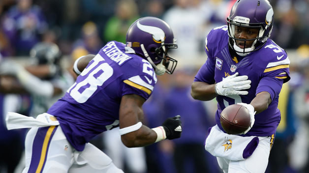 MINNEAPOLIS MN- DECEMBER 6 Quarterback Teddy Bridgewater #5 of the Minnesota Vikings hands the ball to teammate Adrian Peterson #28 against the Seattle Seahawks during the first quarter of the game