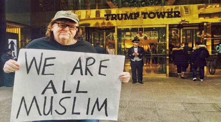 American director Michael Moore holds a placard saying'We are all Muslims in front of Trump Tower Facebook