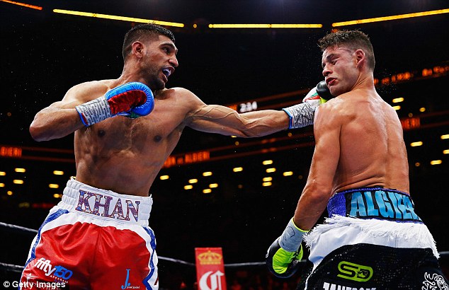 Amir Khan punches Chris Algieri during their welterweight bout at Brooklyn's Barclays Center on May 29