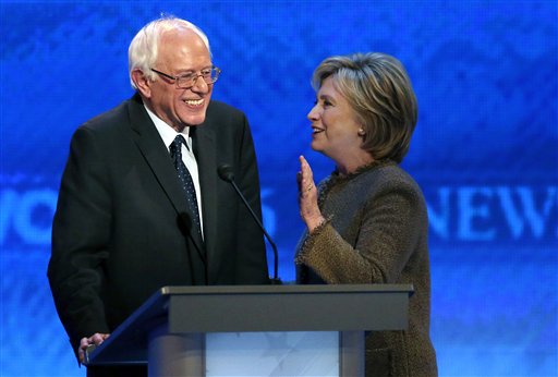 Hillary Clinton right speaks to Bernie Sanders during a break at the Democratic presidential primary debate Saturday Dec. 19 2015 at Saint Anselm College in Manchester N.H