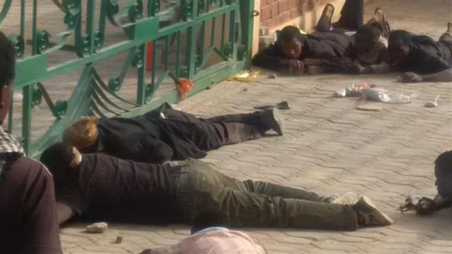 Shia Muslims are seen lying on the ground amid a raid by Nigerian government troops targeting the house of top Shia cleric Ibrahim al Zakzaky in Zaria